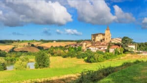 Scenic summer view of Lavardens village in Gascony, Occitanie region, southwestern France, showcasing traditional architecture and lush greenery.